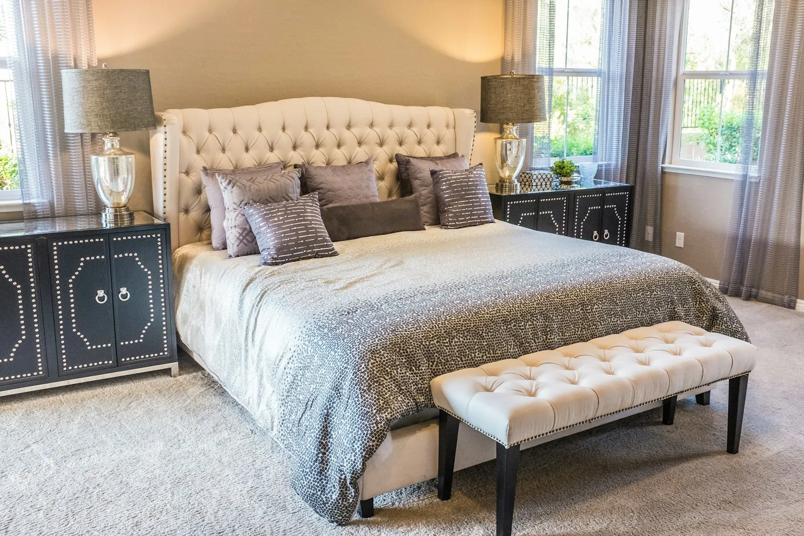 Bedroom with tufted headboard and layered bedding