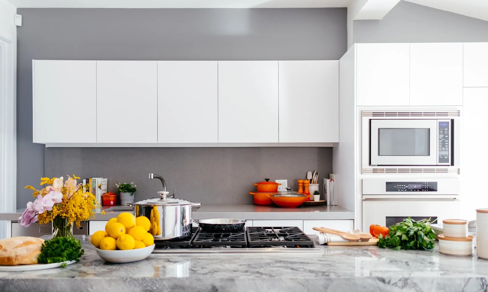 White kitchen with marble counter, cleaned and styled